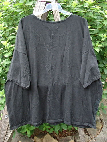 Barclay Center Seam Wide Line Tee Tree Moon Star Black OSFA displayed on a clothes rack, showcasing its rounded neckline, significant drop shoulders, and wide boxy shape with vertical center seam detailing.