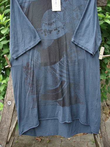 Barclay NWT Tournesol Slim Tunic Turn Moon Navy OSFA displayed on a clothesline; features include drop shoulders, loose three-quarter sleeves, rounded neckline, and a varying hemline, embodying BlueFishFinder's creative vintage style.