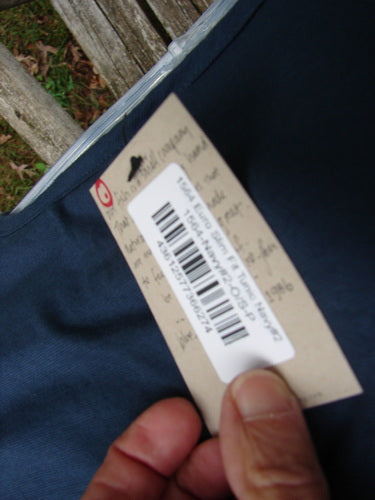 Close-up of a hand holding the Barclay NWT Tournesol Slim Tunic Turn Moon Navy OSFA, showcasing its distinctive drop shoulders, loose three-quarter sleeves, and varying hemline, reflecting BlueFishFinder.com's unique vintage style.