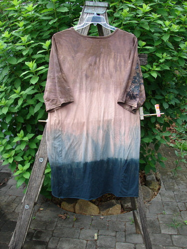 Barclay Tournesol Slim Tunic Dogwood Mottled Dusk OSFA hanging on clothesline, showcasing its longer tunic length, drop shoulders, and varying hemline; a representation of BlueFishFinder's vintage, expressive style.