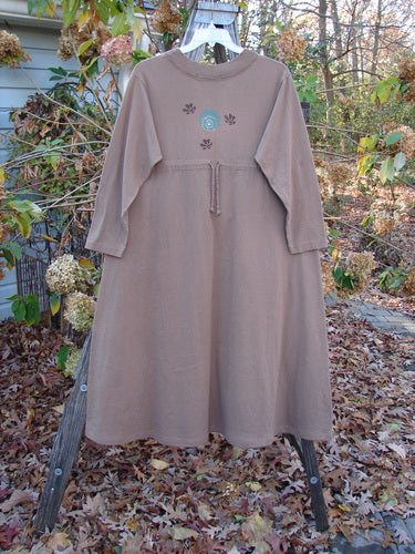 1997 Persian Dress Celtic Moon Mandorla Altered Size 0 features a long, A-line shape with Celtic moon-themed paint, two painted pockets, and a ribbed neckline, hanging on a swing.