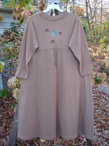 1997 Persian Dress Celtic Moon Mandorla Altered Size 0, mid-length with A-line shape, ribbed neckline, drawcord back, painted pockets, and Celtic moon design, hanging on a clothes rack.