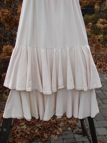 1993 Two Story Skirt Unpainted Tea Dye Small Size 2 displayed on a rack, showcasing its two-tiered flouncy cotton design with a full elastic waistline and wide lower sweep.