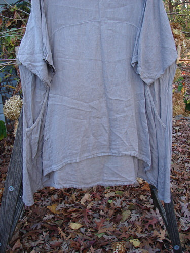 Barclay Linen Urchin Pocket Dress in Unpainted Sand, Size 2, displayed on a clothes rack. This lightweight, short-sleeved vintage dress embodies the unique, expressive style of BlueFishFinder.com.