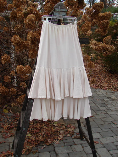 1993 Two Story Skirt Unpainted Tea Dye Small Size 2, featuring ruffles on a rack, showcasing its unique double-layered mid-weight cotton jersey and full thinner elastic waistline.