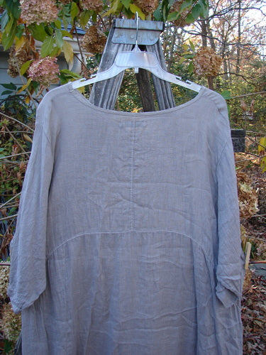 Barclay Linen Urchin Pocket Dress Unpainted Sand Size 2 displayed on a hanger, showcasing its lightweight short sleeves and distinctive pocket design. Perfect for expressing individuality with vintage Blue Fish Clothing flair.