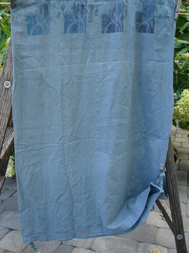 2000 Almost 7 Jumper Rock Wall Blue Mineral Size 1 displayed on a wooden ladder, showcasing button shoulders, deep neckline, yoked waist seam, tapered hemline, and unique tabbed sides.