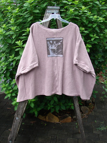 Barclay Celtic Moss Patched Poncho Single Flowerpot Mallow OSFA displayed on a hanger, showcasing its open sides, gathered lower sleeves, and unique flowerpot patch, embodying Bluefishfinder.com's vintage, expressive style.