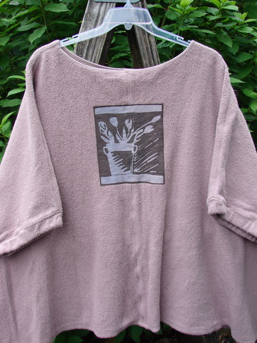 Barclay Celtic Moss Patched Poncho Single Flowerpot Mallow OSFA displayed on a hanger, highlighting its open sides, gathered sleeves, and unique patch, embodying BlueFishFinder's vintage, creative fashion ethos.