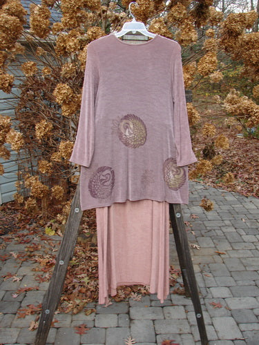1999 Acetate Lycra Camillia Duo Swan Size 1 2: A dress on a rack, featuring a long bird design and a towel on a ladder.