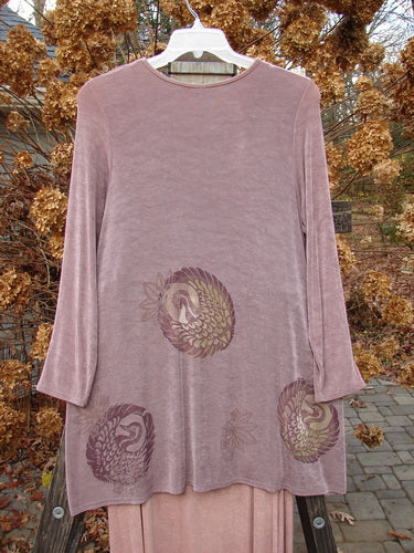 1999 Acetate Lycra Camillia Acetate Duo Swan Size 1 2 displayed on a swing, featuring a floral-themed top and coordinating skirt with varying hemlines and an elastic waistline.