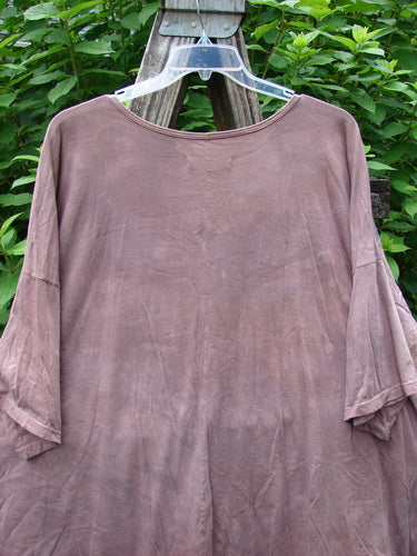 Barclay Center Seam Wide Line Tee Fern Fare Mottled Mauve OSFA displayed on a hanger, showcasing its boxy shape, rounded neckline, and vertical center seam in an outdoor setting.
