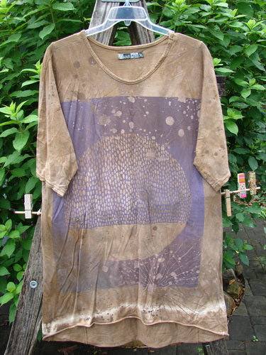 Barclay Tournesol Slim Tunic Moon Rise Mottled Earth OSFA displayed on a rack, showcasing its drop shoulders, loose three-quarter sleeves, rounded neckline, and varying hemline.