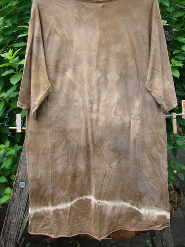 Barclay Tournesol Slim Tunic Moon Rise Mottled Earth OSFA displayed on a clothesline, showcasing its drop shoulders, loose three-quarter sleeves, rounded neckline, and varying hemline, reflecting Bluefishfinder.com's vintage style.