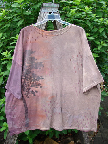 Barclay Center Seam Wide Line Tee Tree Moons Mottled Sunset OSFA displayed hanging, highlighting its boxy shape, drop shoulders, and central seam with a tree and moons pattern on organic cotton.
