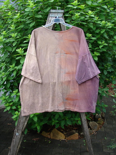 Barclay Center Seam Wide Line Tee Tree Moons Mottled Sunset OSFA displayed on a wooden stand, highlighting its boxy shape, drop shoulders, and vertical center seam, reflecting BlueFishFinder's vintage style.