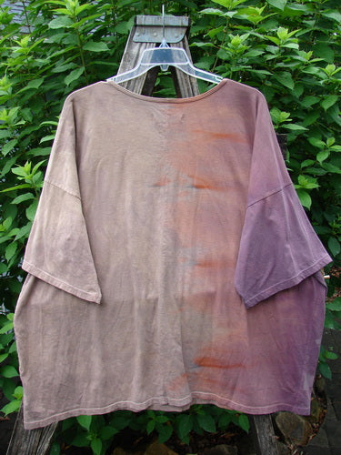 Barclay Center Seam Wide Line Tee Tree Moons Mottled Sunset OSFA displayed on a wooden swing, showcasing its wide boxy shape, rounded neckline, significant drop shoulders, and vertical center seam.