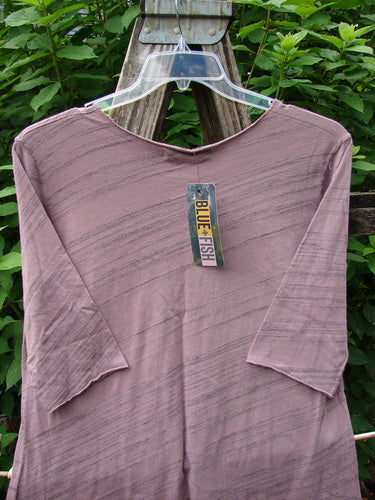 Barclay NWT Viscose Horizon Raw Cut Tee displayed on a hanger, featuring a raw cut neckline, three-quarter sleeves, and floral cluster design, highlighted by a green tag, embodying Bluefishfinder's creative style.