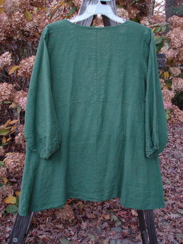 Barclay Linen Deep V Single Button Cardigan Unpainted Jade Size 2 displayed on a hanger, featuring a deep V neckline, empire waist seam, and billowy three-quarter sleeves with elastic edges.