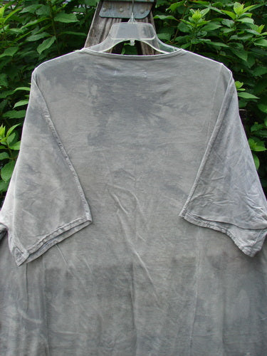 Barclay NWT Art Tee Floral Reach Raincloud Grey OSFA displayed on a clothes rack, showcasing its longer tunic length, drop shoulders, and loose three-quarter sleeves, embodying Bluefishfinder.com's vintage style.