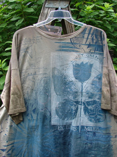 Barclay NWT Center Seam Wide Line Tee Tulip Mottled Brown Blue OSFA displayed outdoors on a hanger, showcasing its wide, boxy shape, dropped shoulders, and vertical center seam against a natural backdrop.