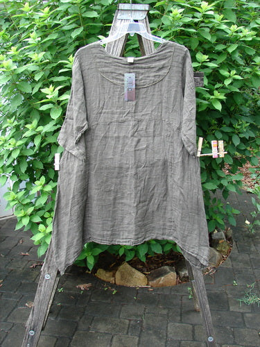 Barclay NWT Linen Cross Over Urchin Pocket Dress Unpainted Earth Size 1 displayed on a clothesline, highlighting its V-neckline, drop shoulders, and unique side lengths, reflecting Bluefishfinder.com's vintage collection.