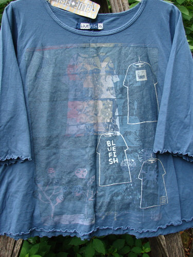 Barclay NWT Crop A Lined Cafe Tee in Echo Blue, featuring a man’s image, rounded neckline, and curly edges. This mid-weight organic cotton tee embodies playful, creative expression.