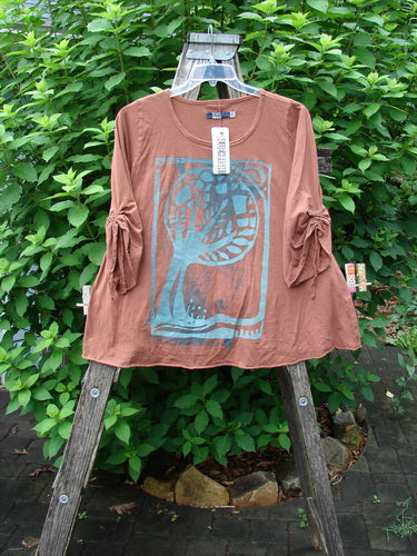 Barclay NWT Draw Gather Sleeve Cafe Top Moon Tree Sedona Size 0 displayed on a wooden stand, showcasing its dynamic moon tree design, swinging A-line shape, and cozy draw-gather sleeves.