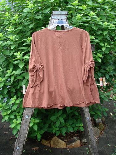 Barclay NWT Draw Gather Sleeve Cafe Top Moon Tree Sedona Size 0, displayed on a wooden ladder, showcases its rounded neckline, A-line shape, and wide sleeves with unique Moon Tree theme paint.