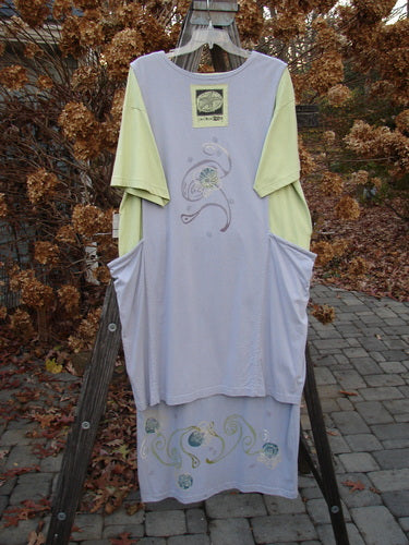 1997 Tunic Dress Curly Garden Dawn Mellon Size 1 on a clothes rack, showcasing its longer, straighter shape with a slightly tapering lower and shallow rounded neckline, featuring a curly garden theme paint.
