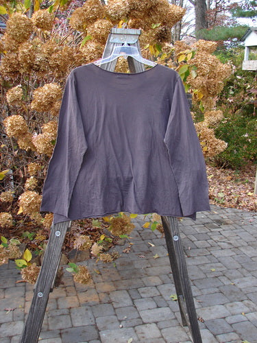 Barclay PMU Patched Batiste Long Sleeved A Line Tee Love Dove Brum Size 2 displayed on a clothes rack, featuring longer narrow sleeves, gentle rounded neckline, and raw rolled edgings.