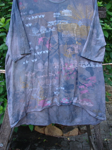 Barclay Tournesol Tunic Farm Land Mottled Grey Sky OSFA features a loose fit, drop shoulders, three-quarter sleeves, and a rounded neckline. Its asymmetrical hem and rolling farm land pattern offer a unique, artistic look.