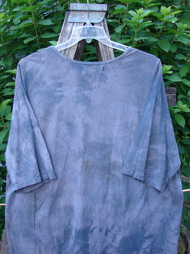 Barclay Tournesol Tunic Farm Land Mottled Grey Sky OSFA displayed on a wooden stand, showcasing its loose three-quarter sleeves, rounded neckline, and varying hemline longer in the back.