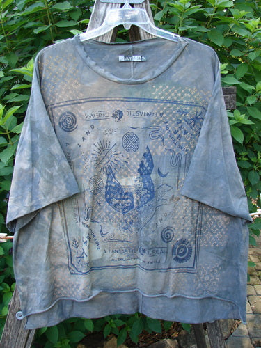 Barclay Raw Edge Flutter Collar High Low Top Blue Fish Love Mottled Steel OSFA displayed on a rack, showcasing its rounded batiste flutter neckline, raw edge dolman sleeves, and high-low hemline.