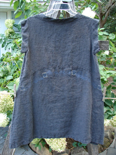 Barclay Linen Mid Layer Cap Sleeve Tunic Heart Black Size 0 hanging on a clothesline, showcasing its varying widening hemline, mock mandarin collar, and tiny heart pattern design.