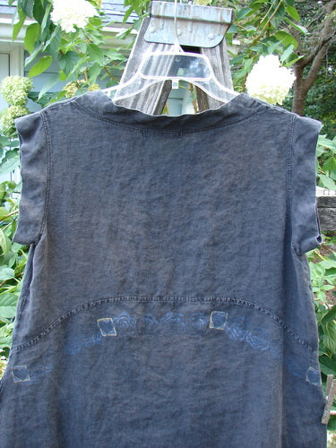 Barclay Linen Mid Layer Cap Sleeve Tunic Heart Black Size 0 displayed on a clothes rack, showcasing its unique downward curved empire waist seam and mock mandarin collar with tiny heart patterns.