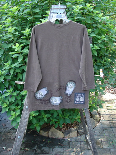 1998 Long Sleeved Vented Tee Tumble Stone Stick Size 1 on a swinger, showcasing its thicker rib neckline, varying shirttail hemline, tiny vented sides, drop shoulders, and Blue Fish patch.
