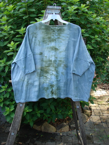 Barclay Dolman Curl Edge Square Pullover Night Star Mottled Moss OSFA displayed outdoors, featuring drop shoulders and seamless design with curly arm edgings, embodying Bluefishfinder.com's vintage and creative ethos.