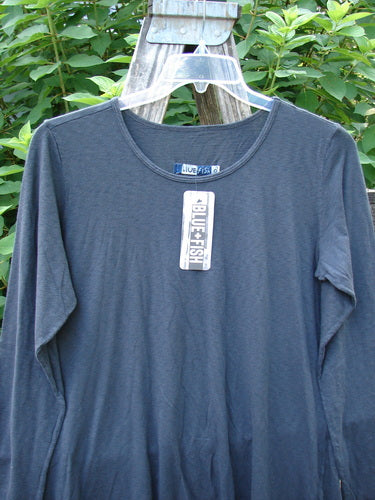 Barclay NWT Modal Batiste Layer Top Unpainted Shadow Size 1 displayed on a hanger, showcasing long sleeves, A-line shape, slight hip flare, raw edges, and a rounded neckline, highlighting its layering-friendly design.