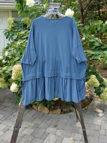 Barclay Batiste Banded Bottom Tunic Quad Sprig Navy OSFA displayed on a swinging mannequin with dolman sleeves, varying hem, and quad sprig pattern, showcasing its generous, boxy shape and rounded neckline.
