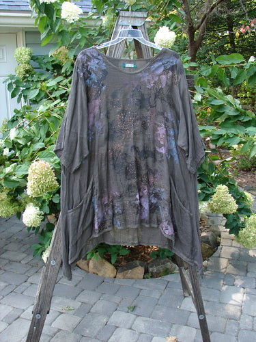 Barclay Linen Drop Pocket Urchin Dress Continuous Bouquet Wood Size 2 displayed on a wooden ladder, showcasing its rounded neckline, three-quarter sleeves, and painted bouquet theme.