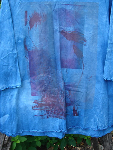 Barclay NWT Three Quarter Sleeved Cafe Tee in Shadow Blend Mottled Blue Sky, featuring a flattering A-line shape, rounded neckline, and curly edgings, displayed on a plant for Bluefishfinder.com.