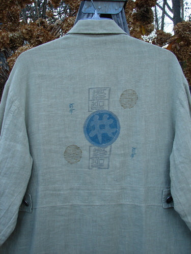 1999 Hemp Yard Coat Far East Cement Size 1: Close-up of a heavy-weight cotton hemp jacket with soft flannel lining, metal buttons, and painted pockets.