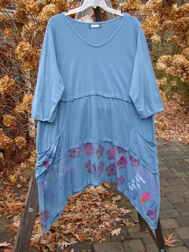 Barclay NWT Raw Seam Vector Dress in Whistler Blue with pink floral pattern, featuring a V-shaped neckline, raw edges, varying hemline, and exterior drop front pockets.