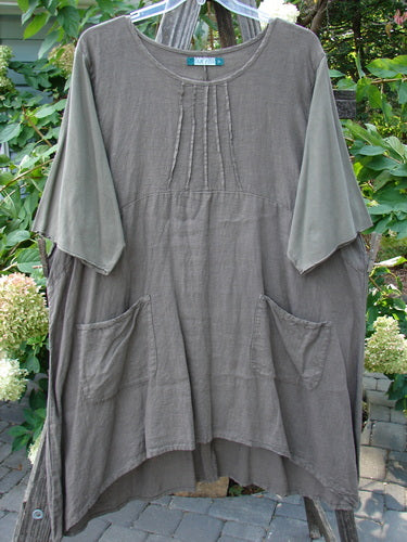 Barclay Linen Cotton Sleeve Milkmaid Dress Unpainted Mushroom Size 2 displayed on a clothes rack; features rounded neckline, pleated upper bodice, empire waist, varying hemline, and front exterior pockets.