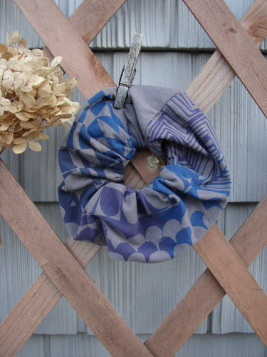 Barclay PMU Cotton & Lycra Hair Scrunchie Diamond Grid Brum Extra Large, displayed on a wooden fence, showcasing its ruffled fabric and elastic band, exemplifying sustainable vintage-inspired design.