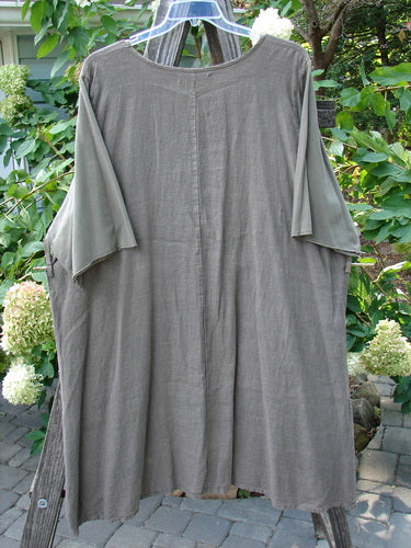 Barclay Linen Cotton Sleeve Milkmaid Dress Unpainted Mushroom Size 2 hanging on a clothesline, showcasing its rounded neckline, sunrise pleats, curved empire waist seam, and varying hemline.