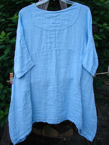 Barclay NWT Linen Cross Over Urchin Pocket Dress Unpainted Splash Size 1, showcasing a smart V-neckline with drop shoulders and unique side pockets, displayed on a hanger, emphasizing its elegant, flowing design.