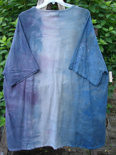 Barclay NWT Art Tee Celestial Mottled Purple Blues OSFA, featuring a tunic length, drop shoulders, loose three-quarter sleeves, rounded neckline, and varying hemline, showcasing a celestial-themed pattern.