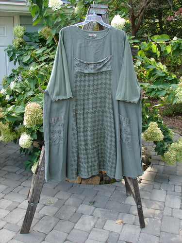 Barclay Cotton Sleeve Upper Pocket Dress Tiny Floral Moss Size 2 displayed on a swing, showcasing the rounded neckline, sectional panels, and three-quarter length sleeves with a drawcord back.